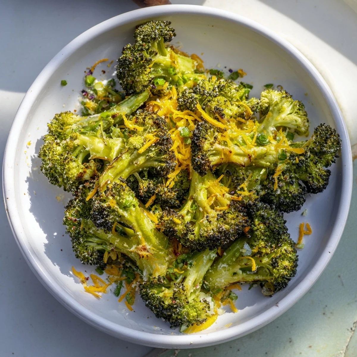 Golden, crispy Simple Garlic and Parmesan Roasted Broccoli ready to serve with a sprinkle of fresh parsley.