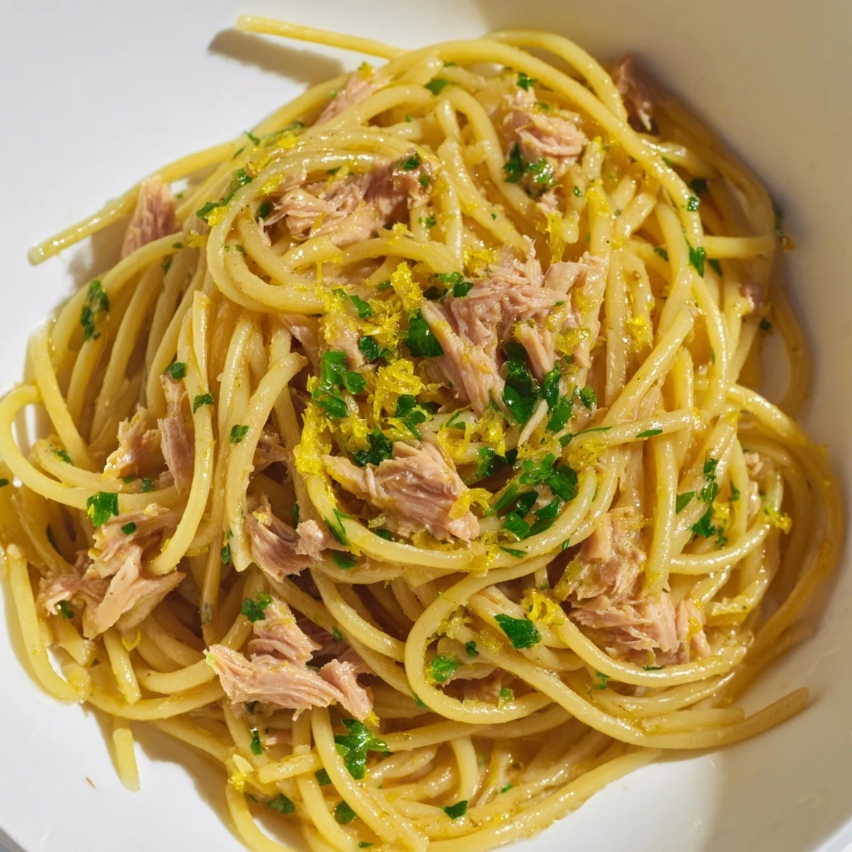 Golden strands of spaghetti tossed with lemon-garlic tuna, a flavorful easy dinner.