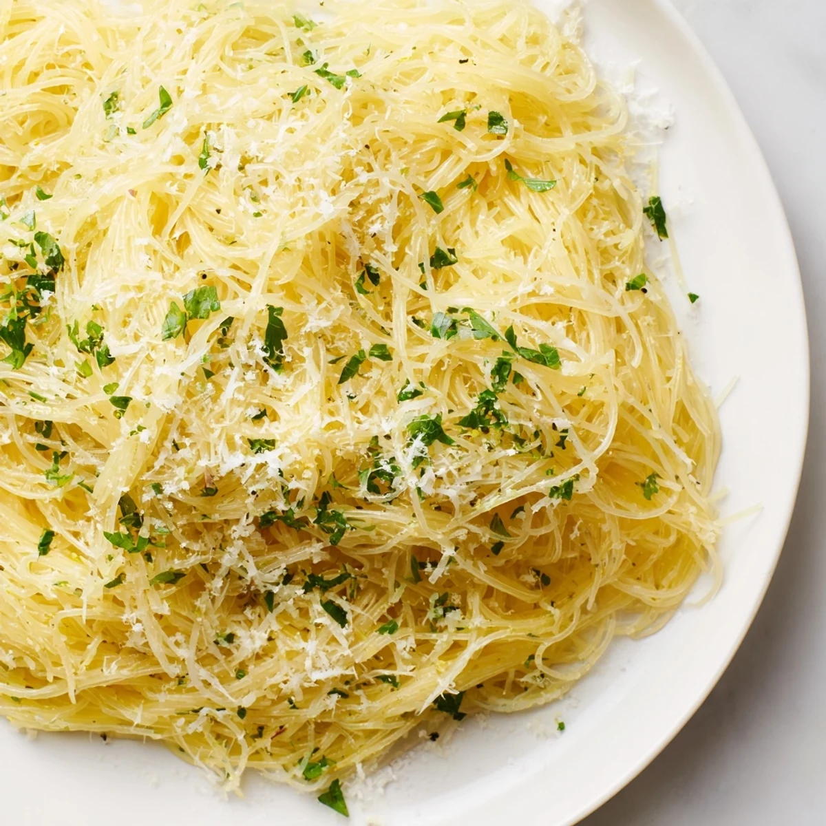 Steaming bowl of Lemon Capellini with herbs: a bright, delicious Italian pasta dinner with fresh zest.