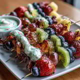 Colorful fruit kabobs arranged in rainbow order, served with luscious honey-lemon yogurt dip, perfect for healthy snacking or party platters.  