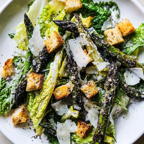 Roasted asparagus spears glisten beside crisp romaine in a vibrant Roasted Asparagus Caesar Salad, topped with golden homemade croutons.  