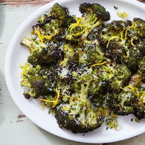 Close-up of Simple Garlic and Parmesan Roasted Broccoli: tender florets, infused with savory Parmesan cheese.