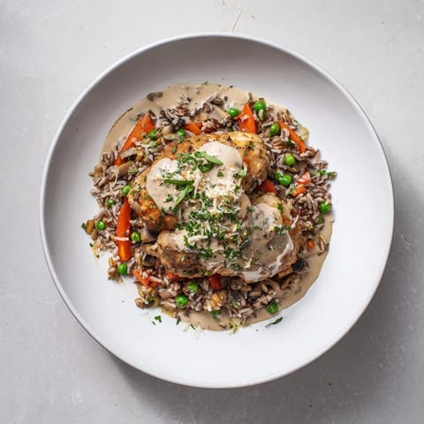 Savory All-in-One Pan Creamy Chicken and Wild Rice, ready to serve, featuring a comforting creamy sauce.