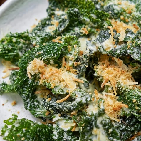 A vibrant Garlic Parmesan Kale Salad featuring tender greens, a zesty lemon-garlic dressing, and crunchy panko breadcrumbs for a satisfying side dish.  
