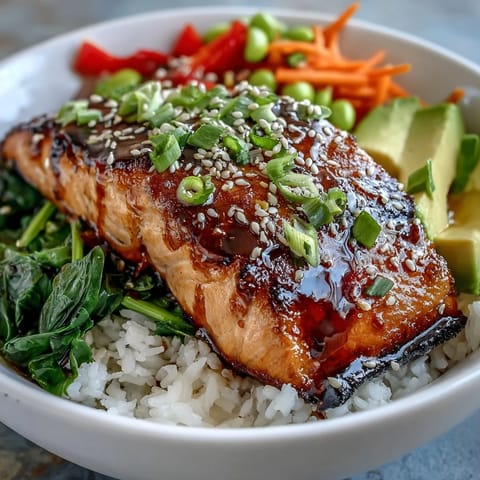 Soy Ginger Salmon Bowl with flaky glazed salmon, fluffy rice, and crisp stir-fried vegetables.