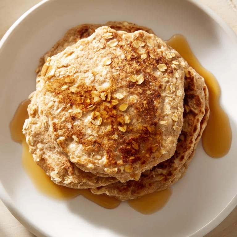 Fluffy banana oat pancakes, cooked to a perfect golden brown, offering a comforting and wholesome start.