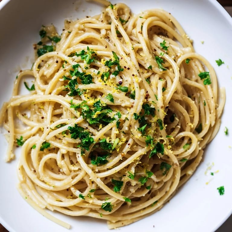 Tender spaghetti coated in glossy garlic butter, a simple yet delicious noodle recipe creation.