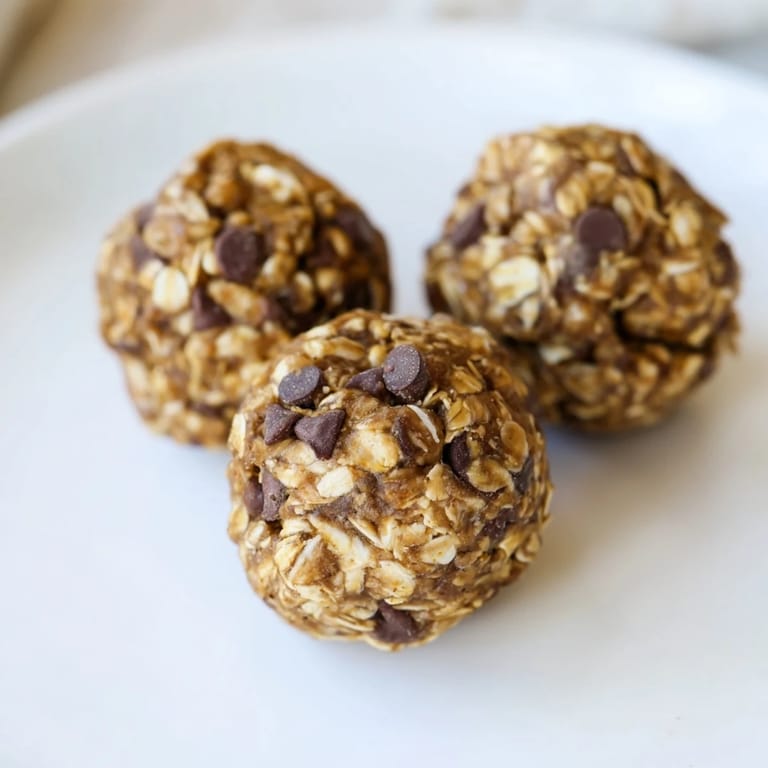 Spoonful of Banana Chocolate Chip Energy Balls mixture showing oats and chocolate chips before rolling into balls.