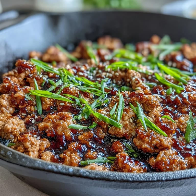 A quick skillet of Korean-Style Ground Turkey finished with toasted sesame seeds and fresh chopped chives.